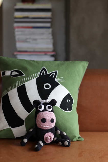 Olive green zebra cushion with knitted cow